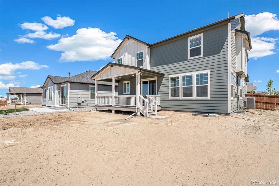 Front exterior of a new home in Farmlore, Brighton, CO, highlighting curb appeal (Image 22).