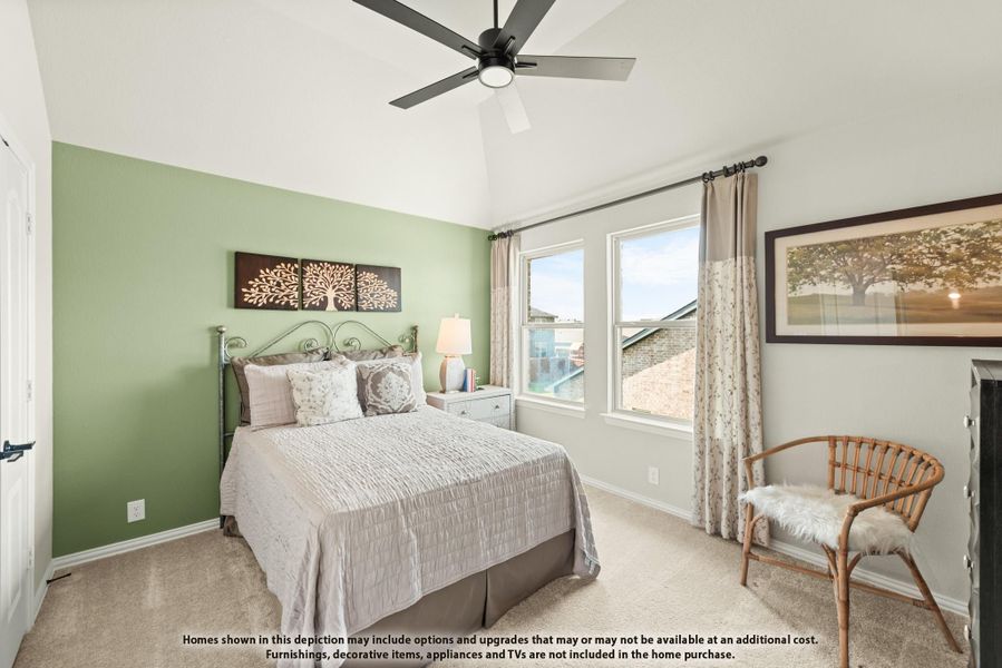 Bedroom with green accent wall, vaulted ceiling, ceiling fan, and carpet flooring Bedroom with green accent wall, vaulted ceiling, ceiling fan, and carpet flooring