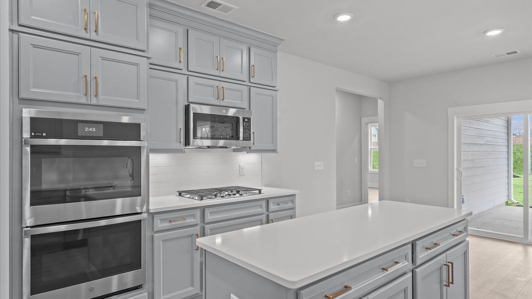 Notable 9-foot island provides generous prep and gathering space in this thoughtfully designed kitchen