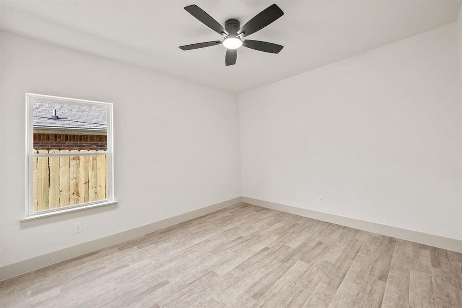 Spare room with light wood-style flooring and a ceiling fan