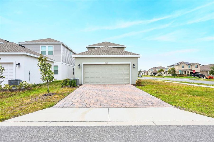 Front exterior of a new home in Tohoqua, Kissimmee, FL, highlighting curb appeal (Image 2).
