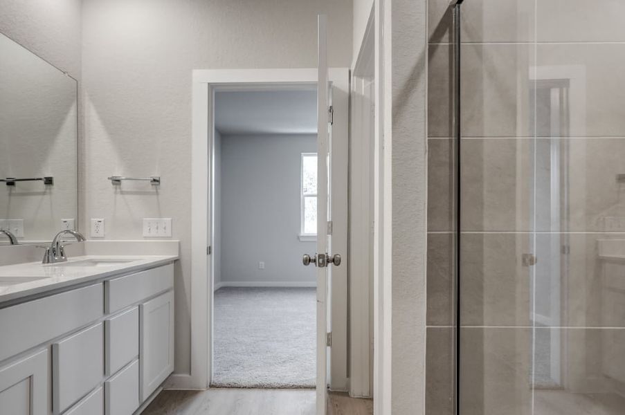 A bathroom with a glass shower. A bathroom with a glass shower.