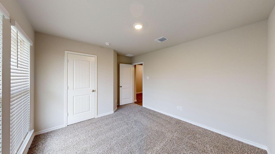 Unfurnished bedroom with carpet floors and a closet