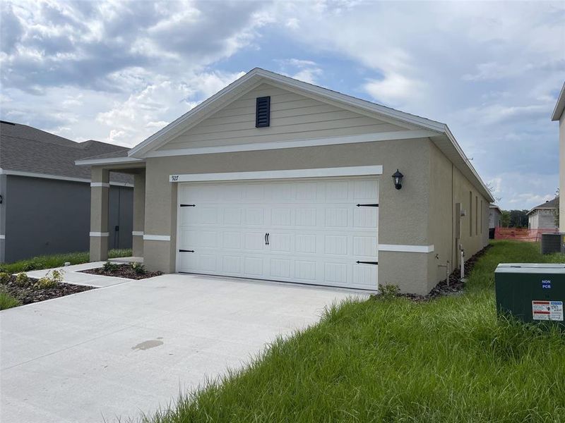 Front exterior of a new home in Cascades, Davenport, FL, highlighting curb appeal (Image 1). Front exterior of a new home in Cascades, Davenport, FL, highlighting curb appeal (Image 1).