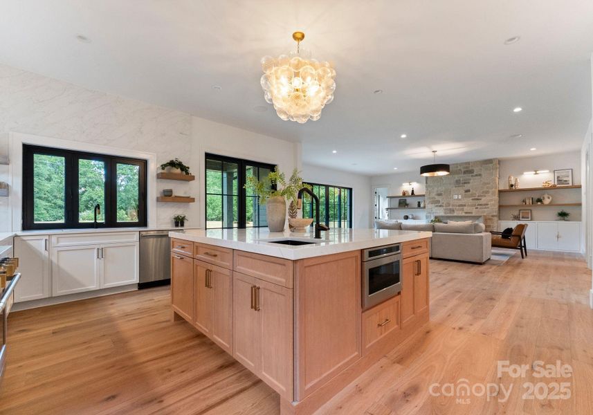 Large accordion window above the sink allows for natural light and easily opens, perfect for fresh air or when entertaining. Large accordion window above the sink allows for natural light and easily opens, perfect for fresh air or when entertaining.