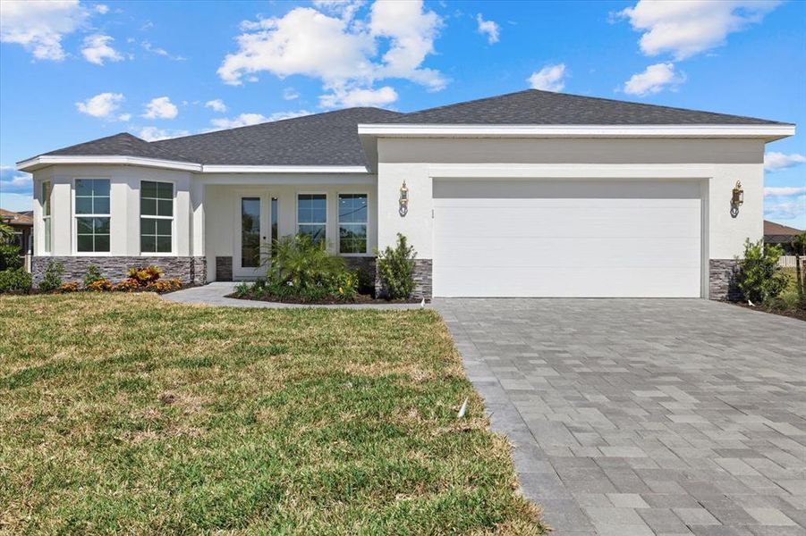 Front exterior of a new home in , Punta Gorda, FL, highlighting curb appeal (Image 1).
