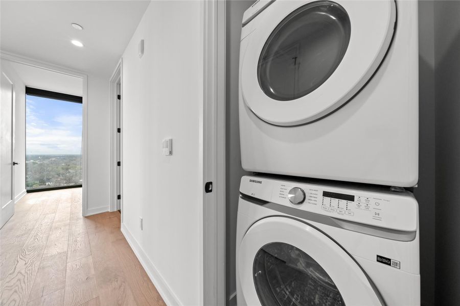 Laundry closet with washer and dryer provided.