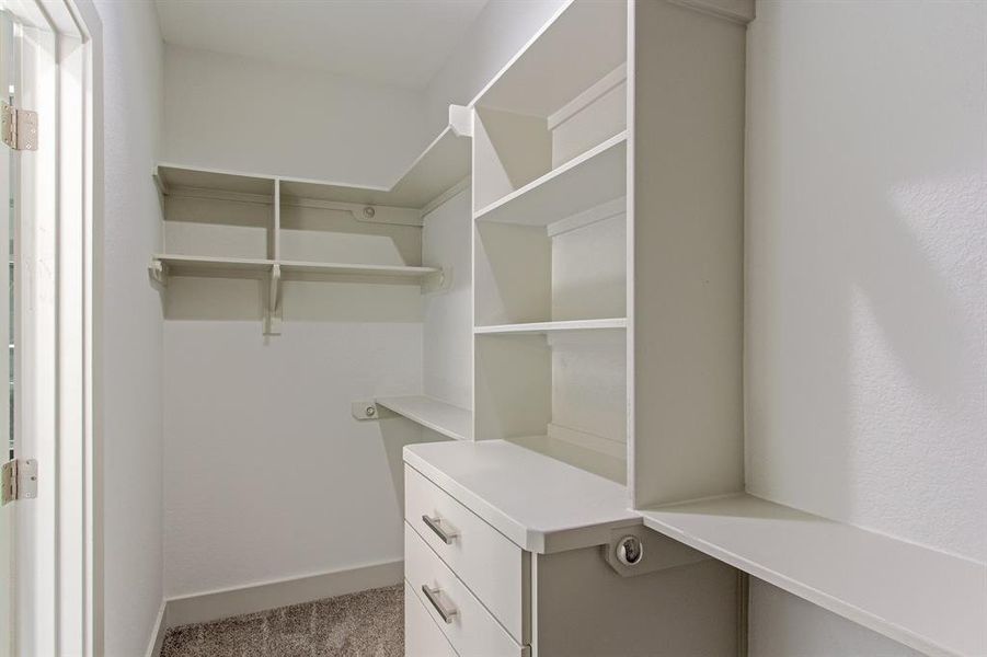 His and hers primary closet with lots of storage.