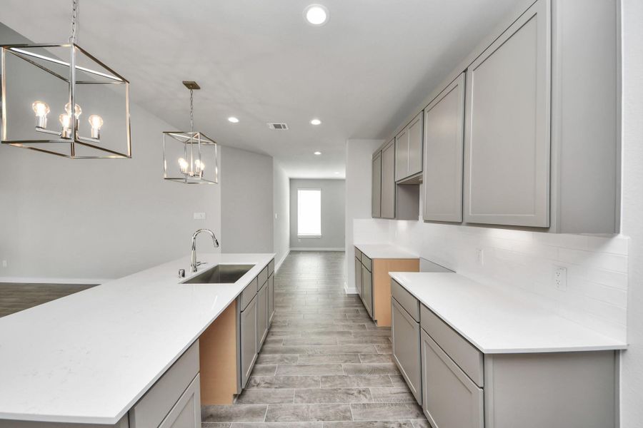 The open concept effortlessly connects the kitchen to the expansive family room, forming a perfect hub for gatherings. This seamless flow creates an inviting space where cooking and socializing come together harmoniously.