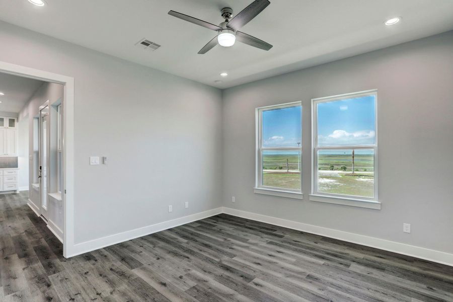 Primary suite is 14'6" X 14' giving plenty of room for a full bedroom set & room for a small sitting area. The windows overlook the canal side of the home. Primary suite is 14'6" X 14' giving plenty of room for a full bedroom set & room for a small sitting area. The windows overlook the canal side of the home.