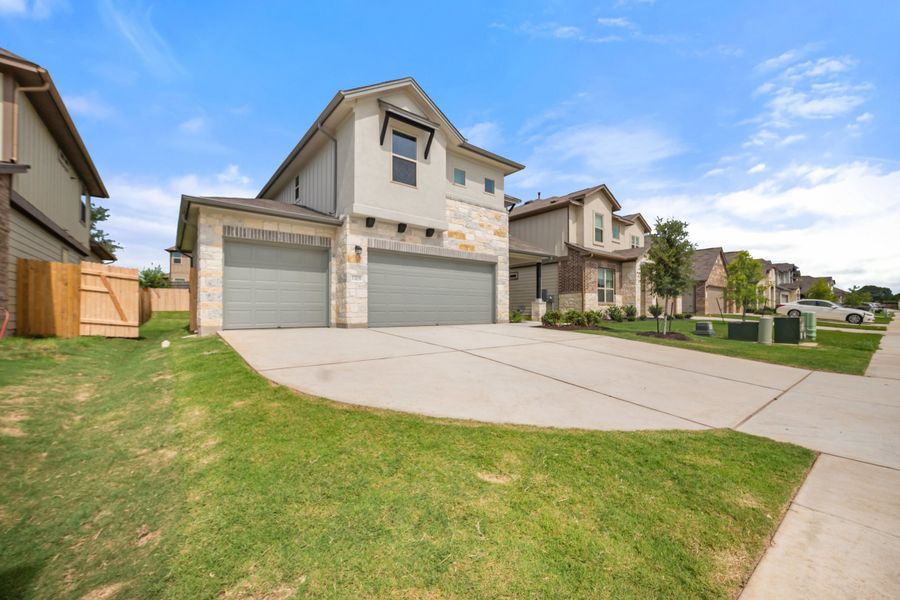 Front exterior of a new home in The Hills of Bear Creek, Manchaca, TX, highlighting curb appeal (Image 5).