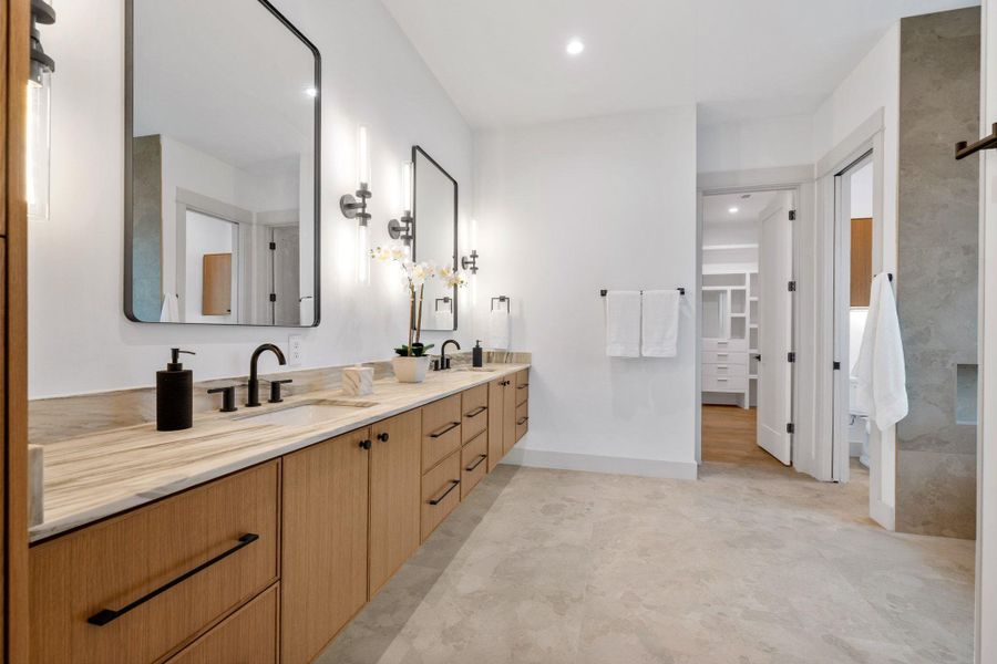Bathroom with Marble double vanity and recessed lighting