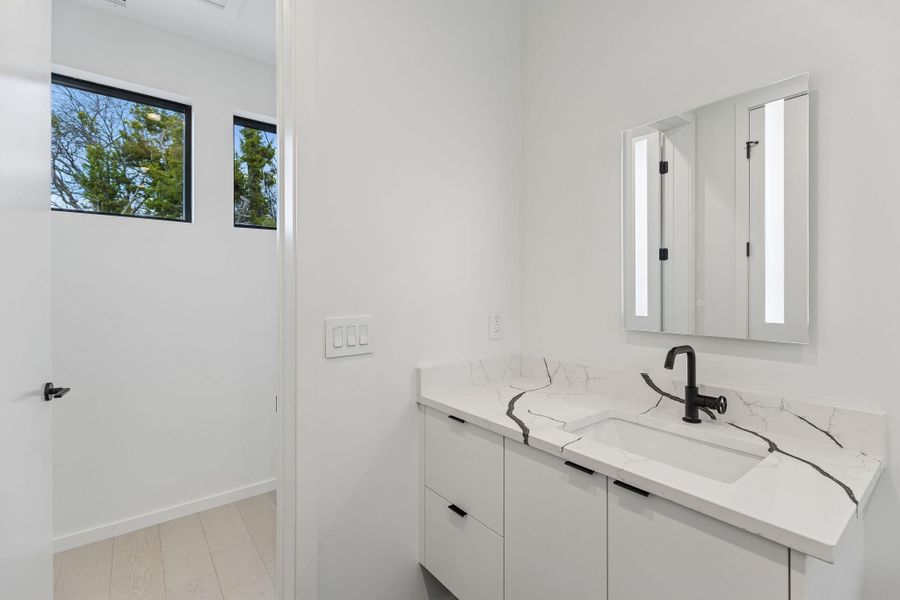 Bathroom featuring vanity and baseboards