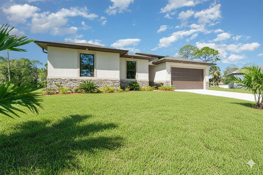 Front exterior of a new home in , Palm Bay, FL, highlighting curb appeal (Image 2). Front exterior of a new home in , Palm Bay, FL, highlighting curb appeal (Image 2).