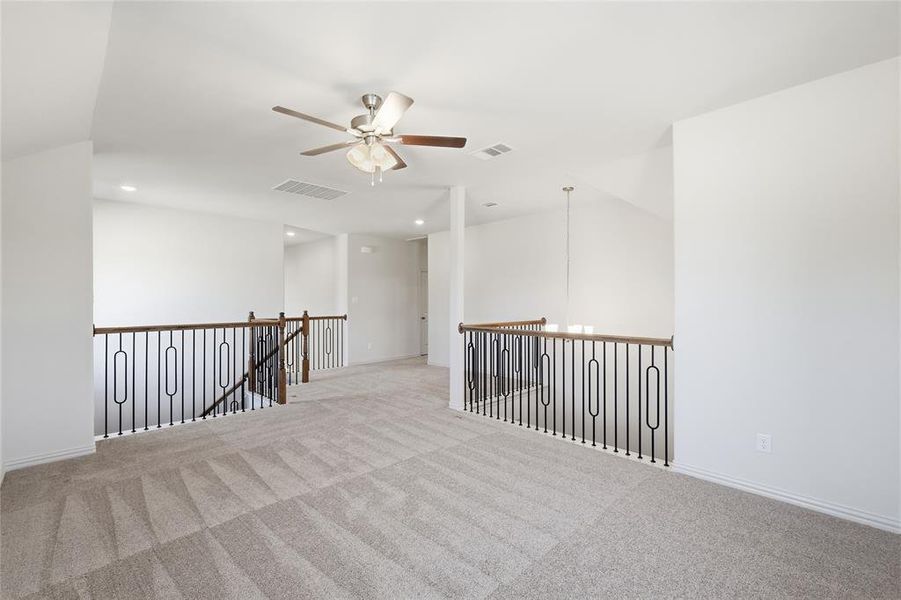 Spare room featuring recessed lighting, carpet, and a ceiling fan