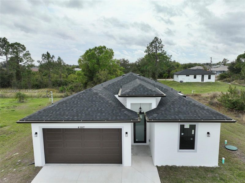 Front exterior of a new home in , Lehigh Acres, FL, highlighting curb appeal (Image 25).