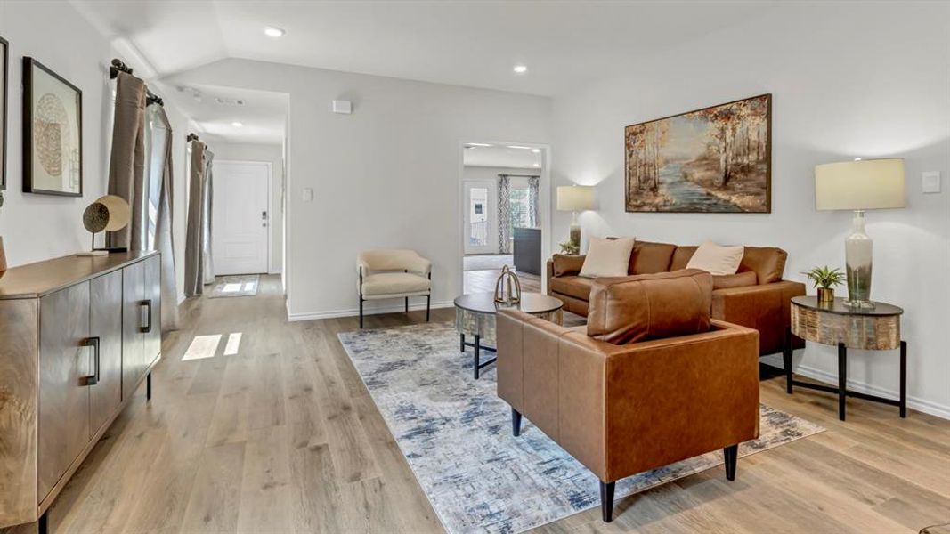 Living room featuring light wood finished floors and recessed lighting Living room featuring light wood finished floors and recessed lighting