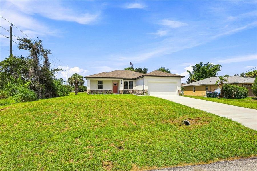 Front exterior of a new home in , North Port, FL, highlighting curb appeal (Image 2). Front exterior of a new home in , North Port, FL, highlighting curb appeal (Image 2).