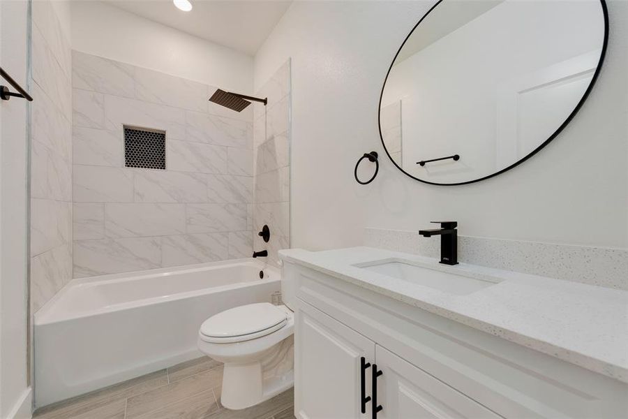 Bathroom with toilet, vanity, and shower / bathing tub combination