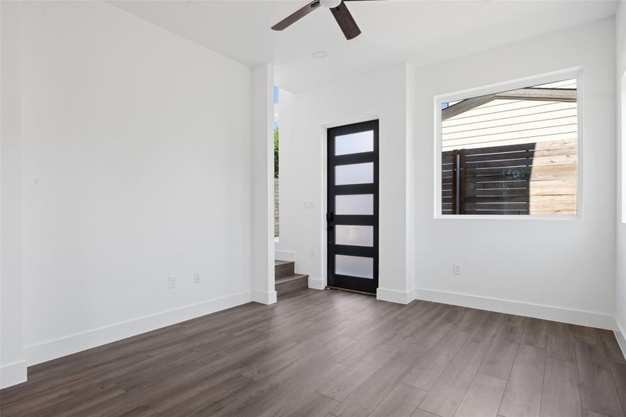 Entrance foyer with dark wood-type flooring, plenty of natural light, and ceiling fan Entrance foyer with dark wood-type flooring, plenty of natural light, and ceiling fan