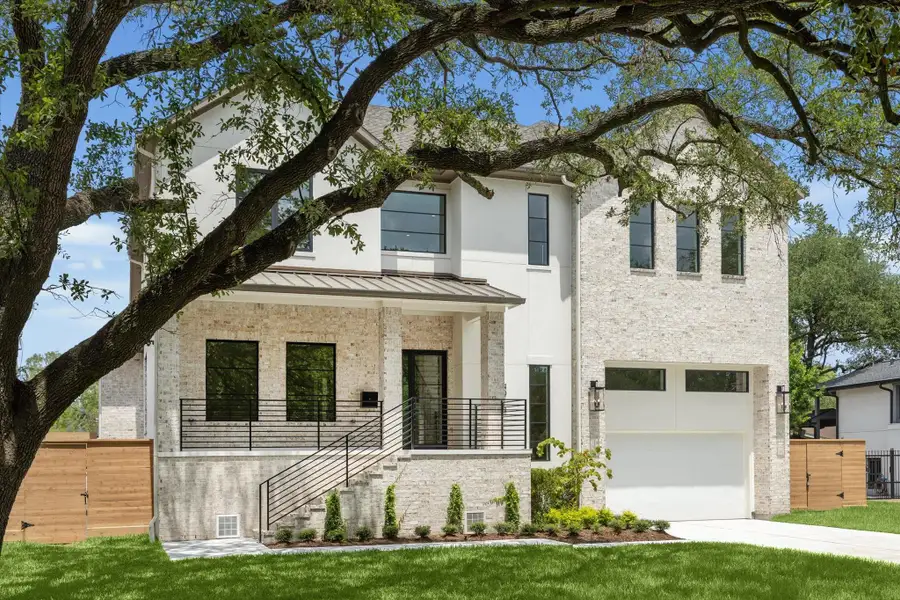 Welcome to 4914 Wigton Drive. This stunning new construction features a light brick facade with stucco accent and a welcoming covered front porch.