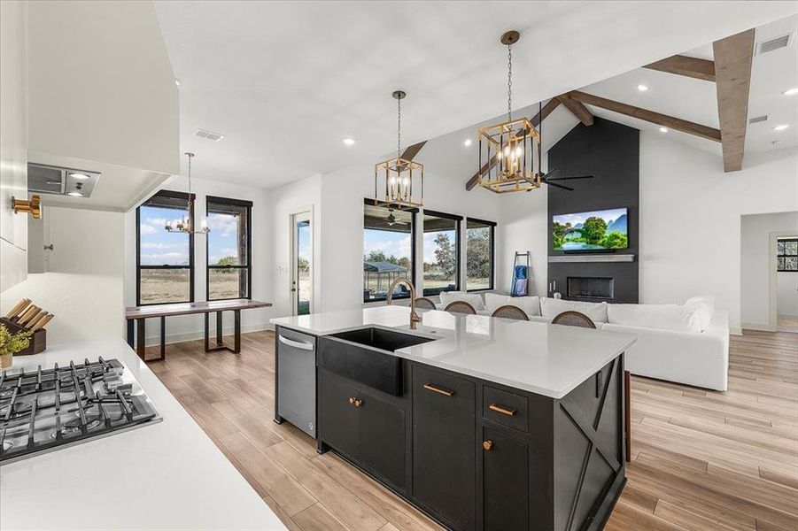 Open concept kitchen has massive island with space for 4 chairs  with tons of storage under counter.