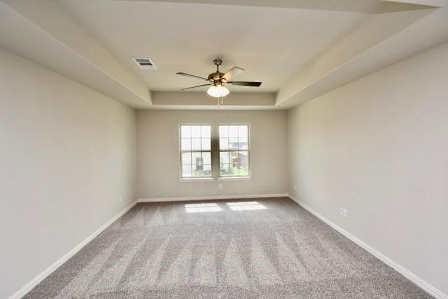 Primary bedroom custom panned ceiling, and a ceiling fan Primary bedroom custom panned ceiling, and a ceiling fan