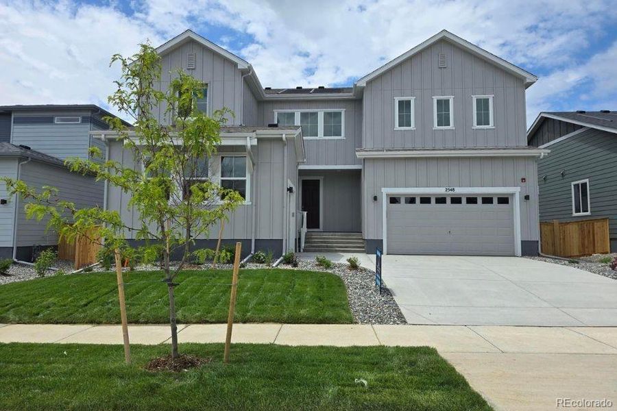 Front exterior of a new home in Prestige Collection at Parkdale Commons, Lafayette, CO, highlighting curb appeal (Image 1).