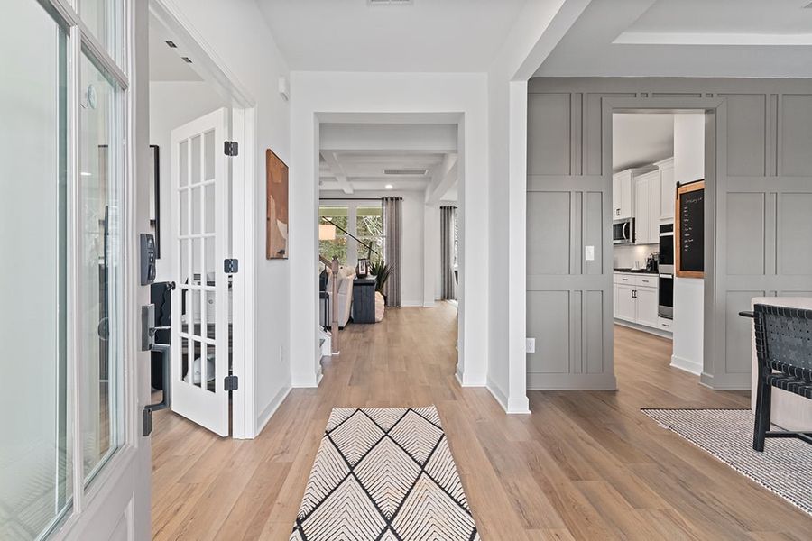 A room with white walls and wood floors.