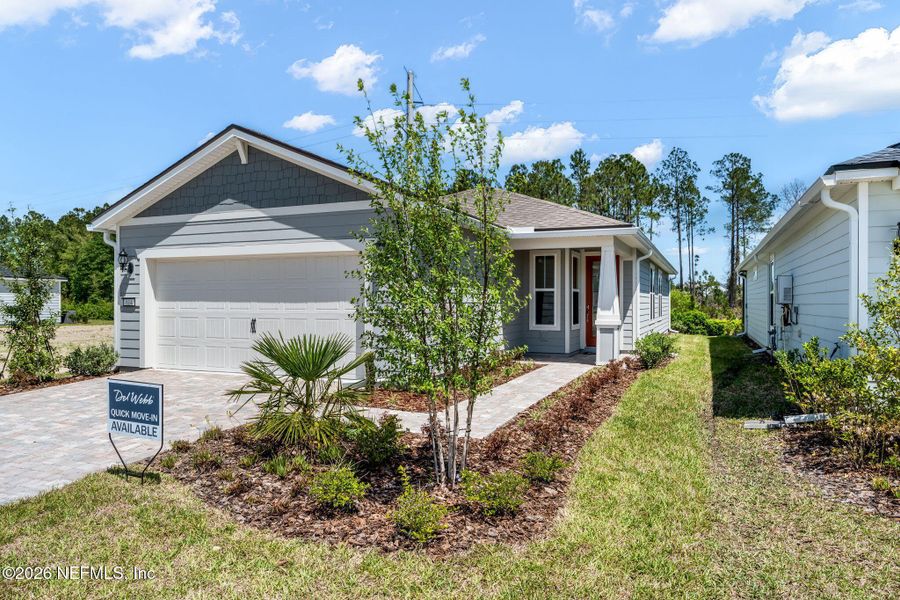 Front exterior of a new home in Del Webb Wildlight, Yulee, FL, highlighting curb appeal (Image 24).