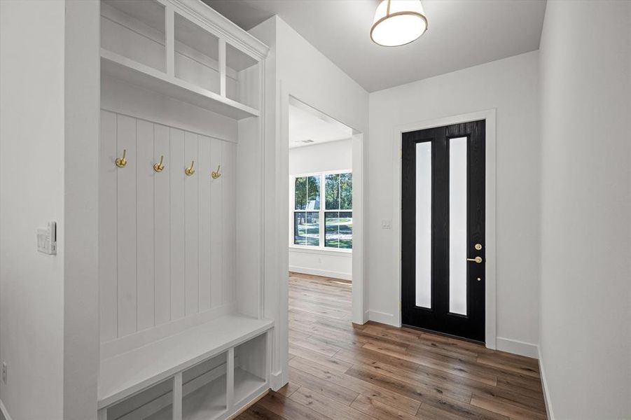 Mudroom featuring hardwood / wood-style flooring and baseboards