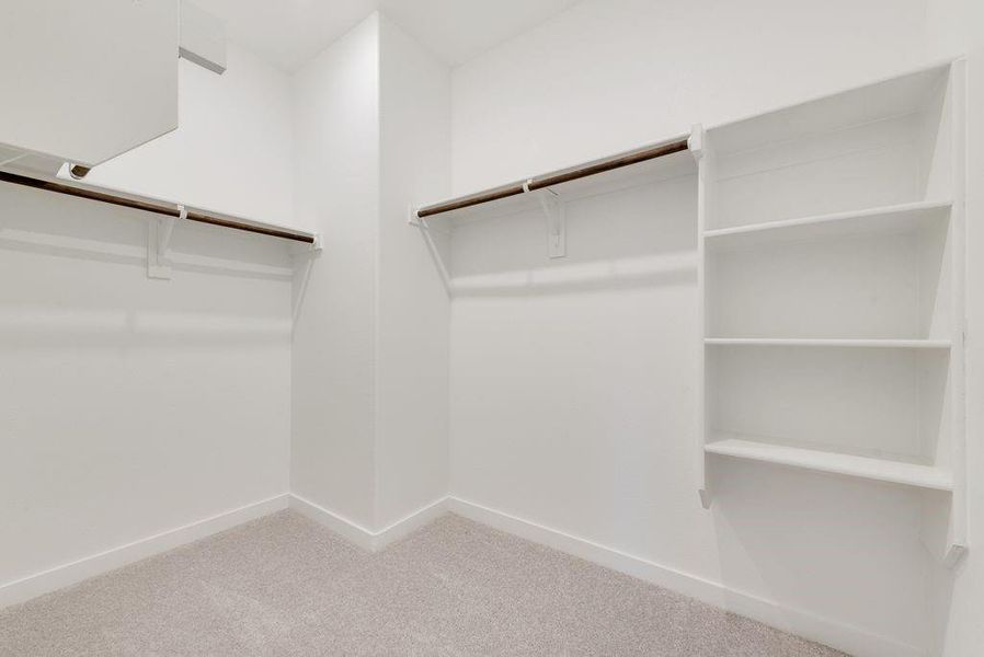 Walk in closet with light colored carpet Walk in closet with light colored carpet