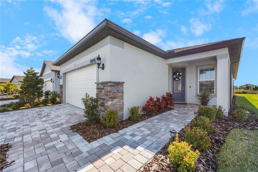 Welcome! Stone accents, paver drive and walkway. Love the 3/4 glass insert door