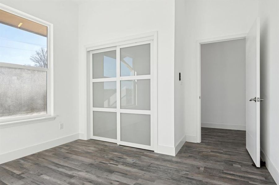 Spare room with baseboards and wood finished floors