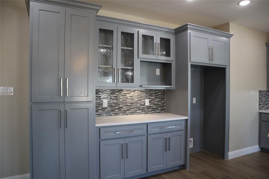 Light blue cabinetry and sleek backsplash