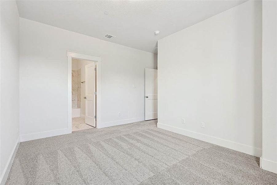 This room features light-colored walls and patterned carpeting
