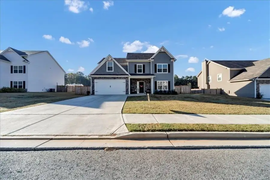 Front exterior of a new home in Traditions at Cedarcrest, Dallas, GA, highlighting curb appeal (Image 25). Front exterior of a new home in Traditions at Cedarcrest, Dallas, GA, highlighting curb appeal (Image 25).