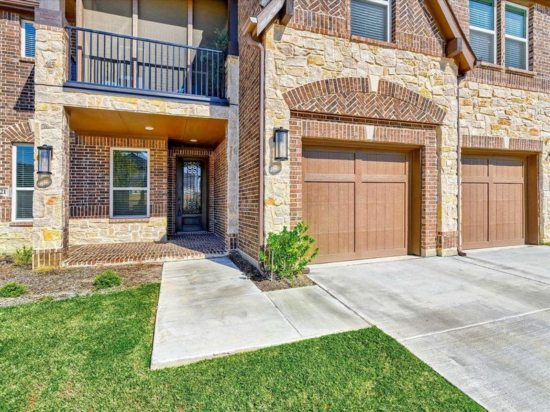 Doorway to property featuring a balcony and a lawn Doorway to property featuring a balcony and a lawn