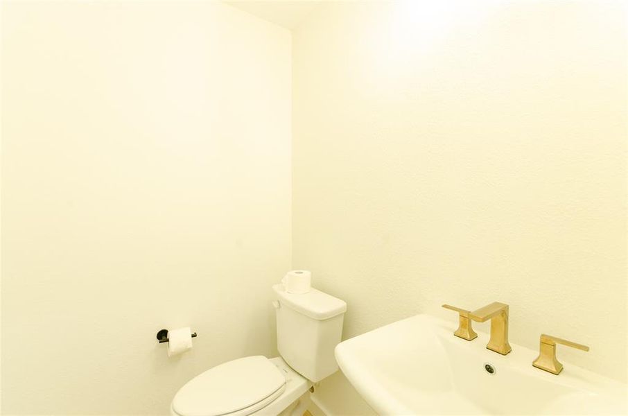Half bathroom featuring toilet and a sink
