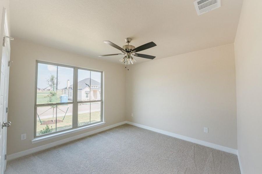 Unfurnished room featuring light carpet and ceiling fan Unfurnished room featuring light carpet and ceiling fan