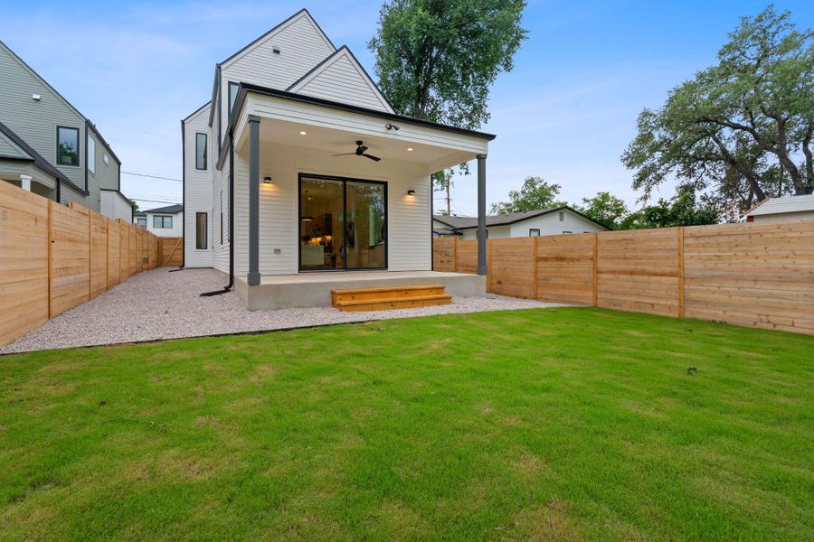 Rear view of property with ceiling fan, a fenced backyard, and a patio Rear view of property with ceiling fan, a fenced backyard, and a patio