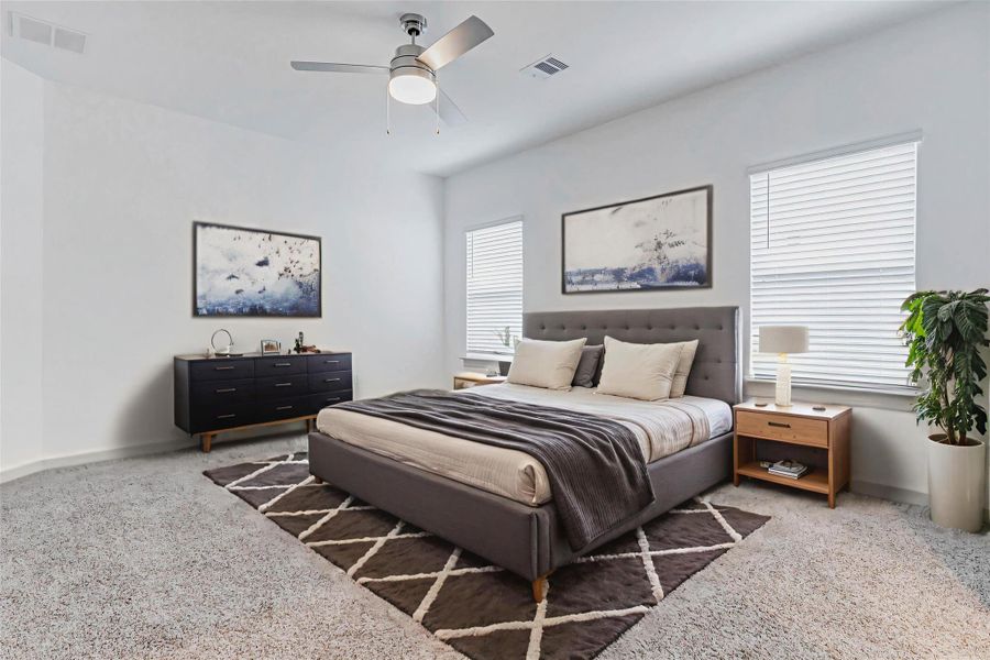 A restful retreat awaits in this spacious primary bedroom with cozy carpet, soft natural light from dual windows, and a sleek ceiling fan. The neutral walls and plush flooring offer a calm, modern canvas ready to personalize and make your own. A restful retreat awaits in this spacious primary bedroom with cozy carpet, soft natural light from dual windows, and a sleek ceiling fan. The neutral walls and plush flooring offer a calm, modern canvas ready to personalize and make your own.