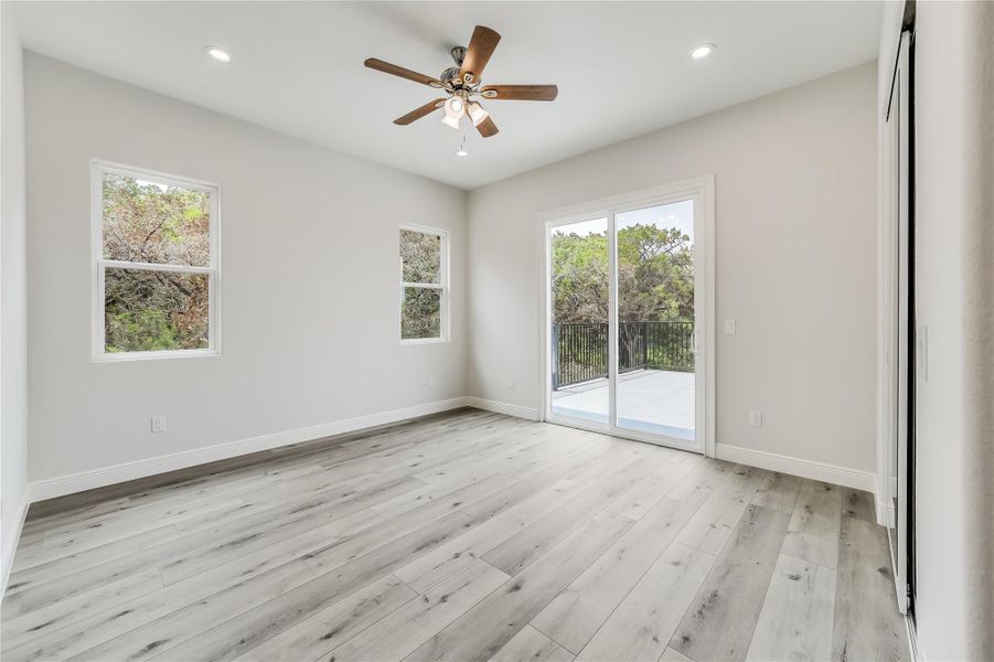 Spare room with ceiling fan and light wood-type flooring