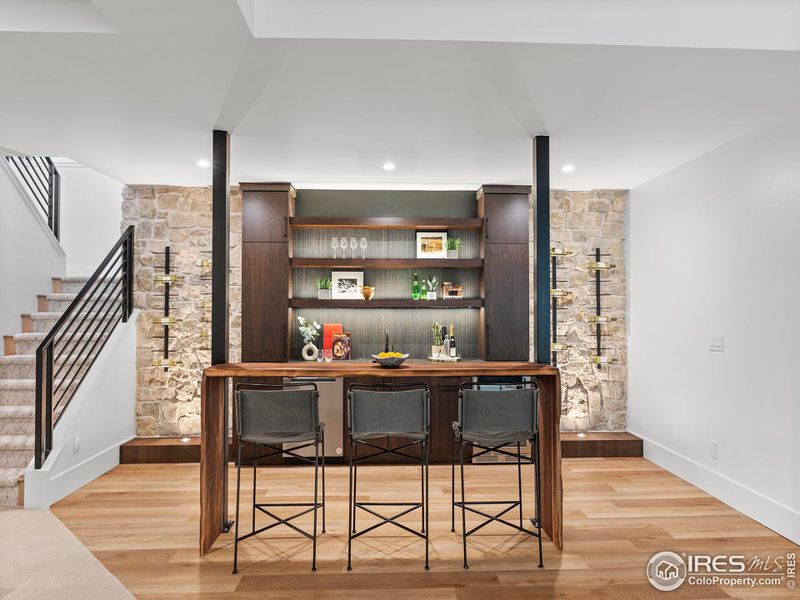 Basement bar with wine racks and custom live edge bar top