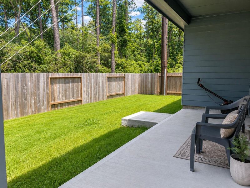 Covered back patio provides the perfect space for morning coffee, outdoor dining, or relaxing while enjoying the private, tree-lined setting with no back neighbors Covered back patio provides the perfect space for morning coffee, outdoor dining, or relaxing while enjoying the private, tree-lined setting with no back neighbors