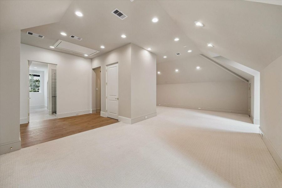 As you enter the third floor, you are greeted by a generously-sized gameroom with access to a full bath, and an additional bedroom space.