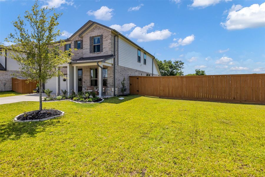 An additional view of the spacious front lawn highlights the well-maintained outdoor area and the home’s inviting curb appeal.