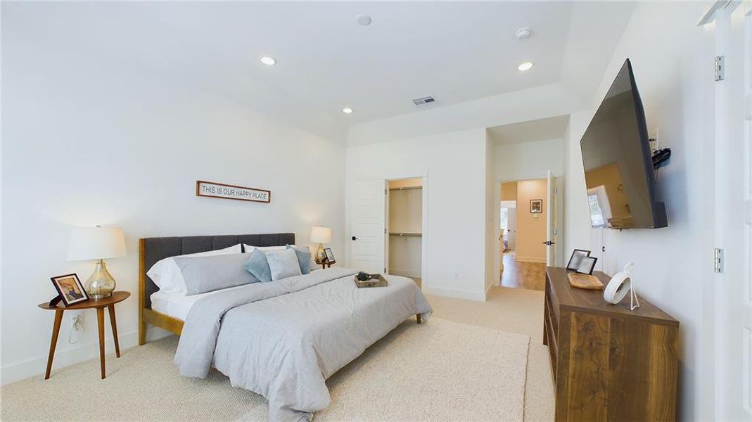 Elegant & spacious primary bedroom located on the 2nd floor. The high ceilings, with recessed lighting, are prewired and blocked for ceiling fans (not included).