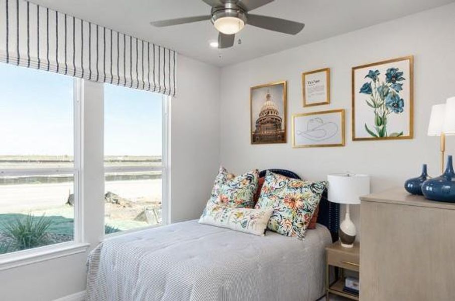 Bedroom featuring multiple windows and ceiling fan Bedroom featuring multiple windows and ceiling fan