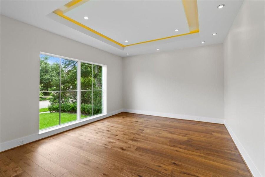 Home also features a parlor or lounge in the front with a lit floating ceiling panel and art lights...large windows